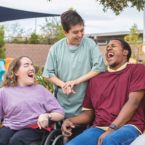 Three people with disabilities laughing. 