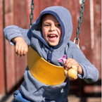 Photo of smiling child on a swing