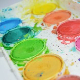 a close up photo of a colorful watercolor paint tray