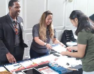 Easterseals DC MD VA staff organizing resources at the Expo table.