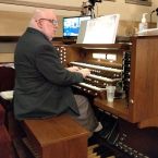 Scott plays the organ at a church