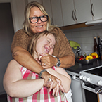 Mother hugging adult child with Down syndrome