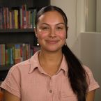 A photo of Jahaira wearing a pink shirt and smiling.