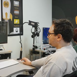 A program participant working on a computer at the Lift Zone Lab.