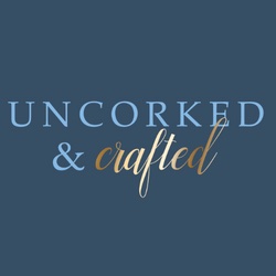 blue background with the words Uncorked & Crafted in light blue and gold