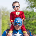 Child and dad in superhero costumes