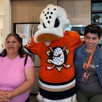 The Ducks mascot (center) standing with Easterseals participants on either side.