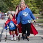 Child and mom walking at run for the kids