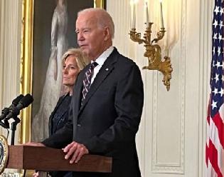 Joe Biden and Jill Biden standing at a podium in the White House