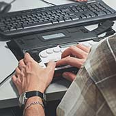 accessibility tool with compute keyboard being used by a man
