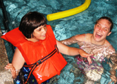 child wearing lifejacket in swimming pool