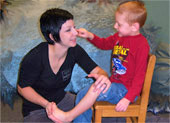 therapist working with young boy who is sitting