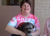 Easter Seals client petting a dog